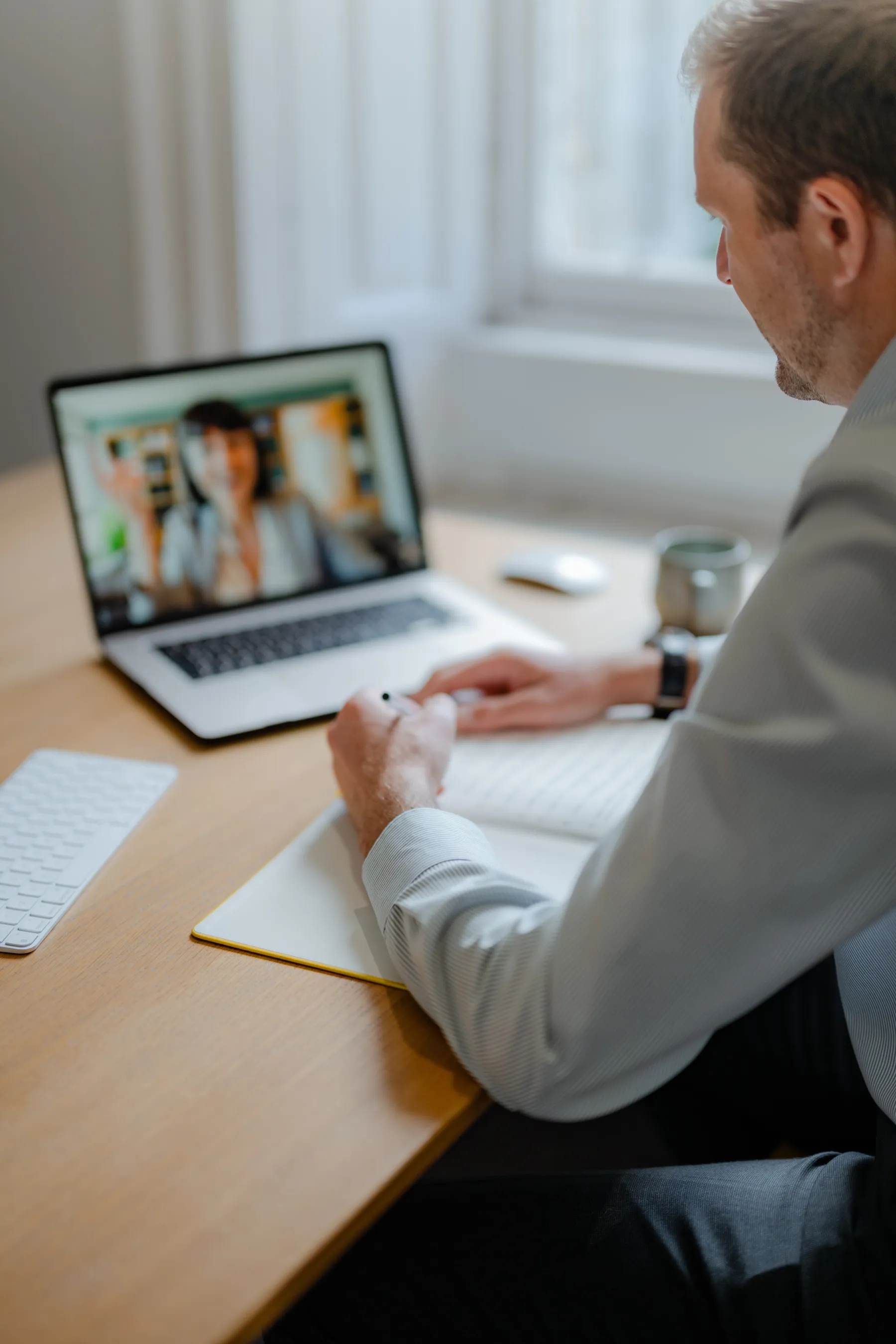 Nat Baldwin at a desk on a video call with a client